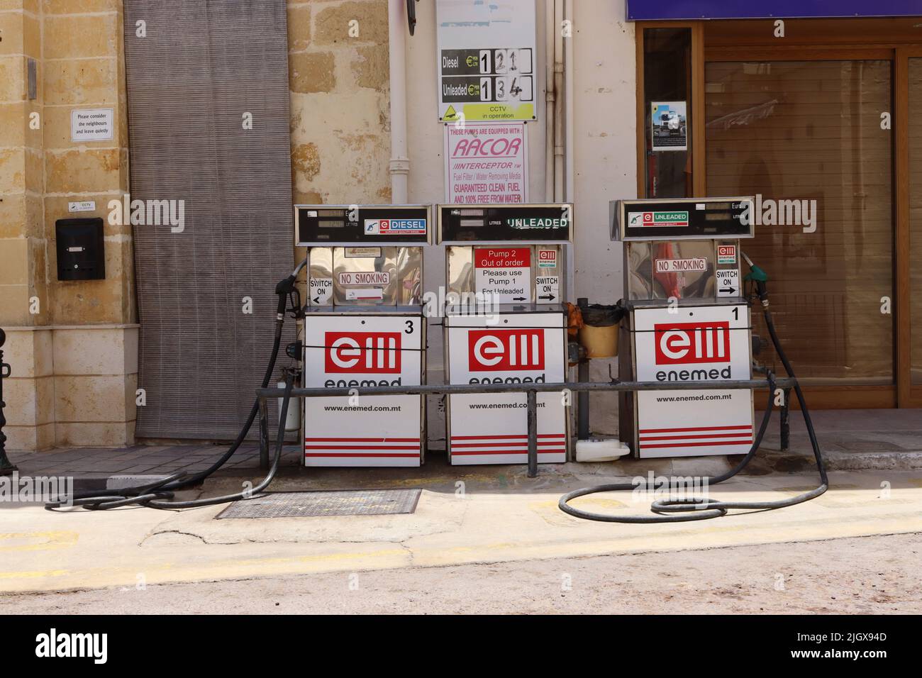 The unique positioning of petroleum spirit fuel pumps mounted at the roadside by Maltese fuel import, distribution and wholesaler Enemed. Stock Photo