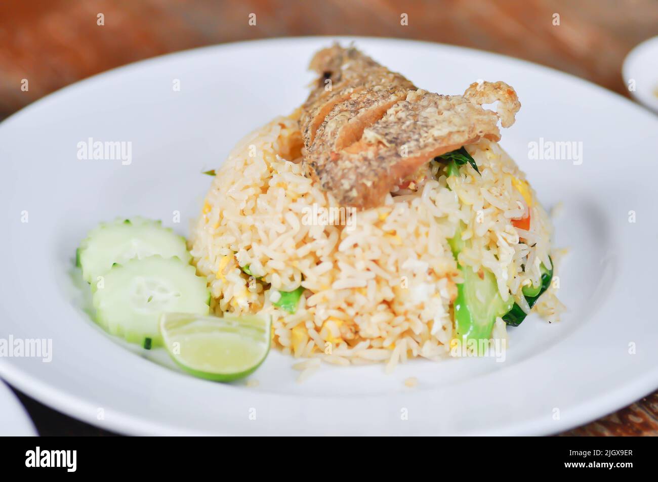 stir fried rice or fried rice with fried fish topping and sauce, fish