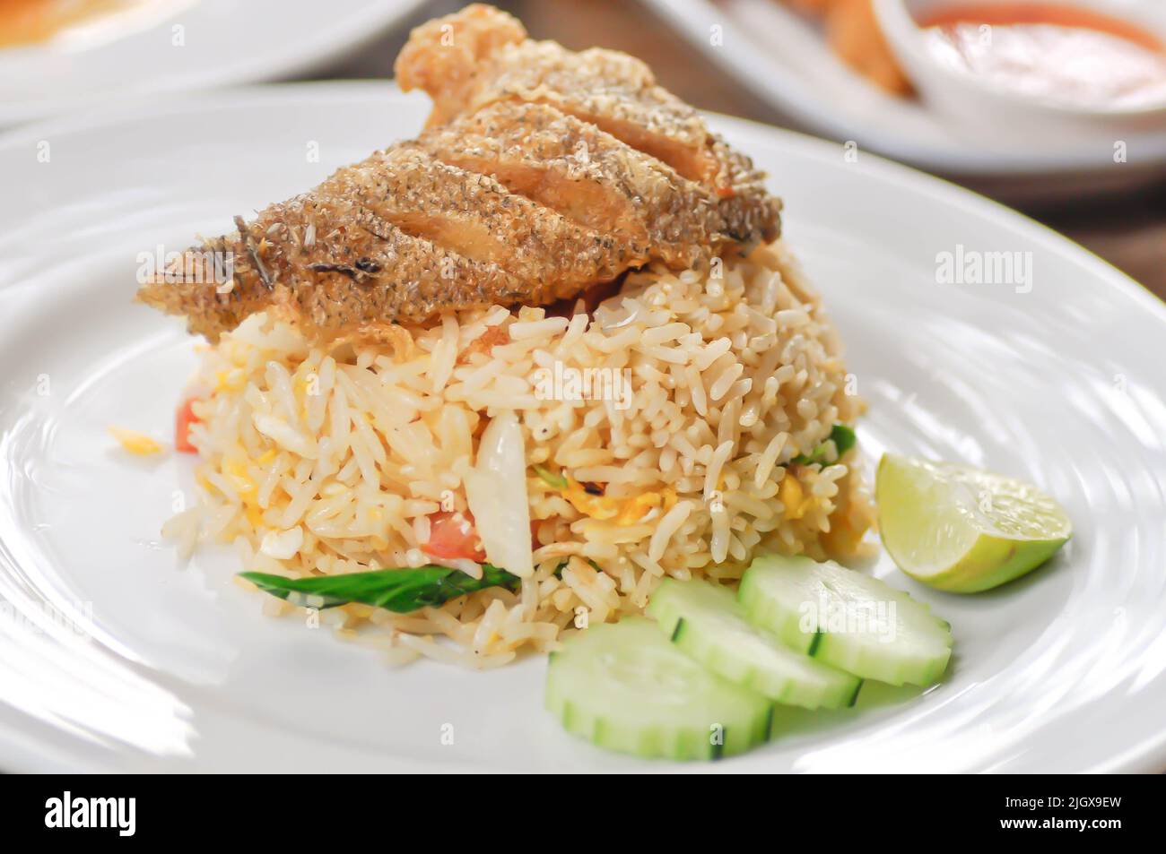 stir fried rice or fried rice with fried fish topping and sauce, fish