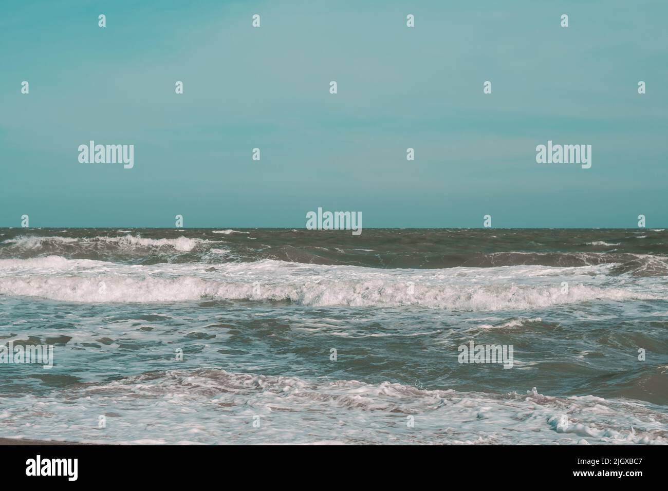 Ocean storm waves dramatically crashing splashing. Sky horizon line