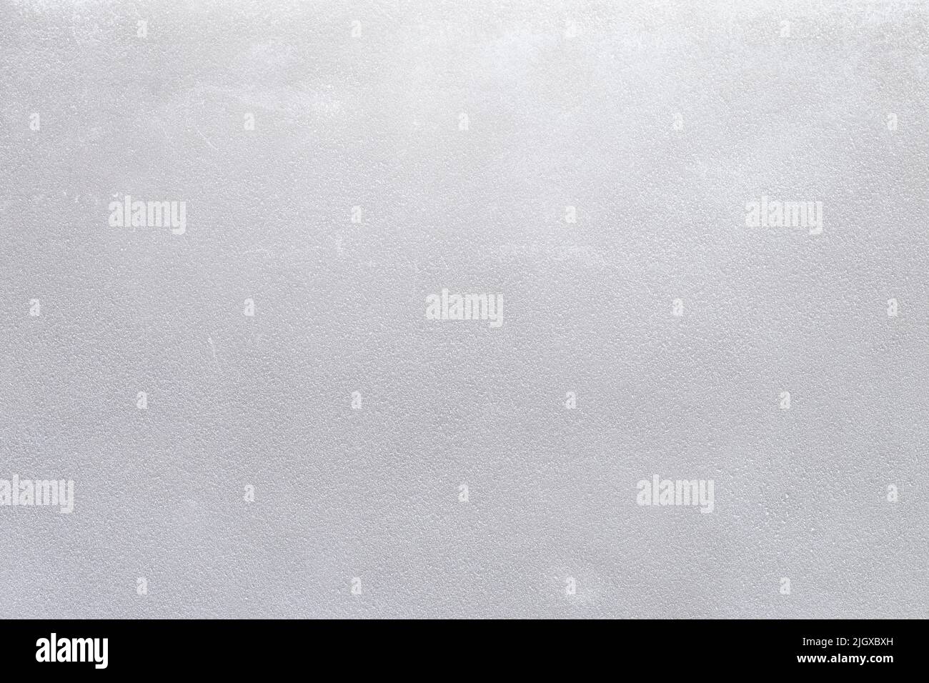 Plastered concrete or stone wall painted in white, front view. High resolution full frame textured background. Copy space. Stock Photo