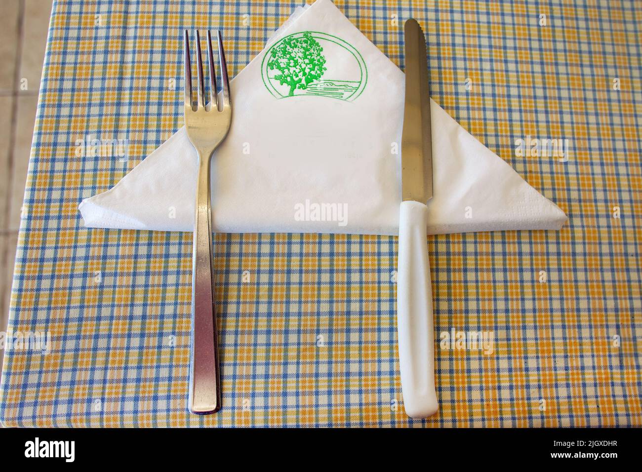 fork and knife on a napkin waiting for a dish  -  amaz ing Cyprus  ( Fig tree Bay in summer!) Stock Photo