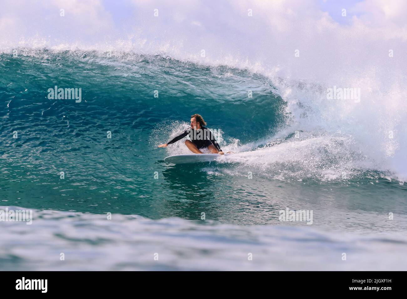 Male surfer on a wave, Maldives Stock Photo