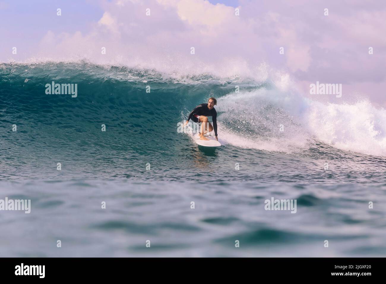Male surfer on a wave, Maldives Stock Photo