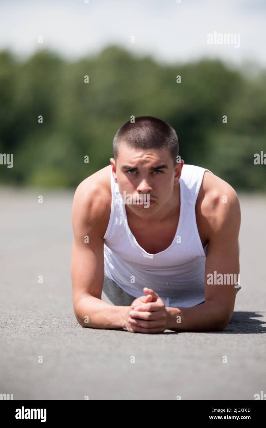 A Nineteen Year Old Teenage Boy Doing The Plank In A Public Park Stock ...