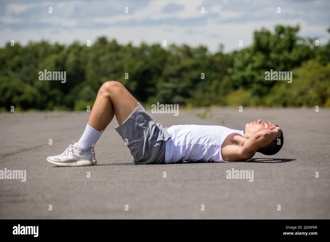 A Year Old Teenage Boy Doing Situps In A Public Park Stock