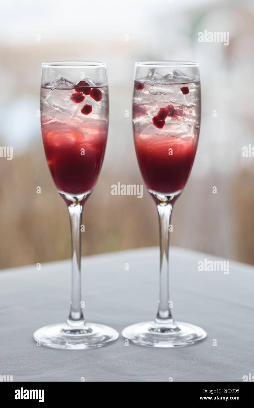 Two cranberry and pomegranate cocktails in champagne glasses Stock Photo