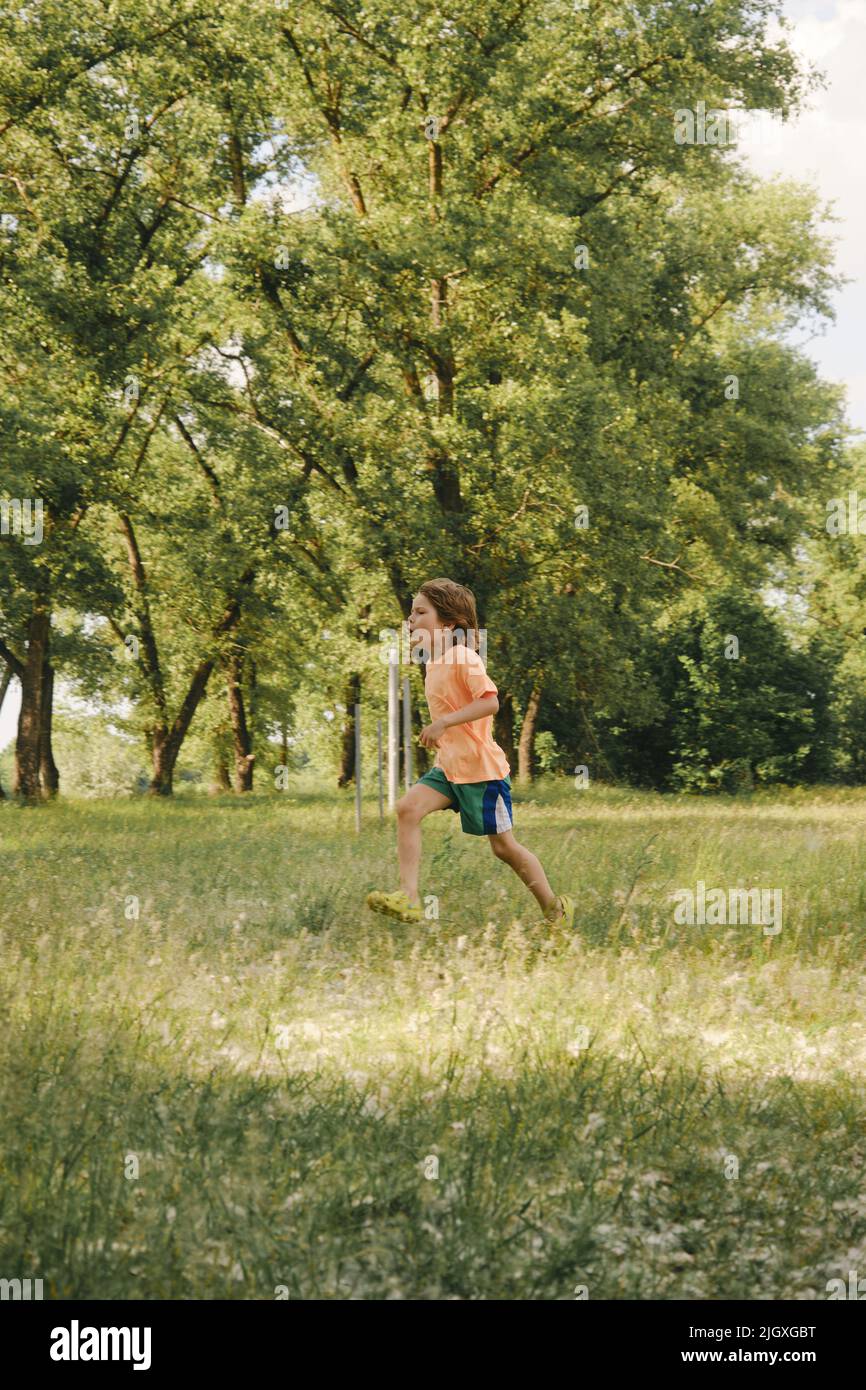 Kid playing outdoors, sport summer day activity Stock Photo Alamy