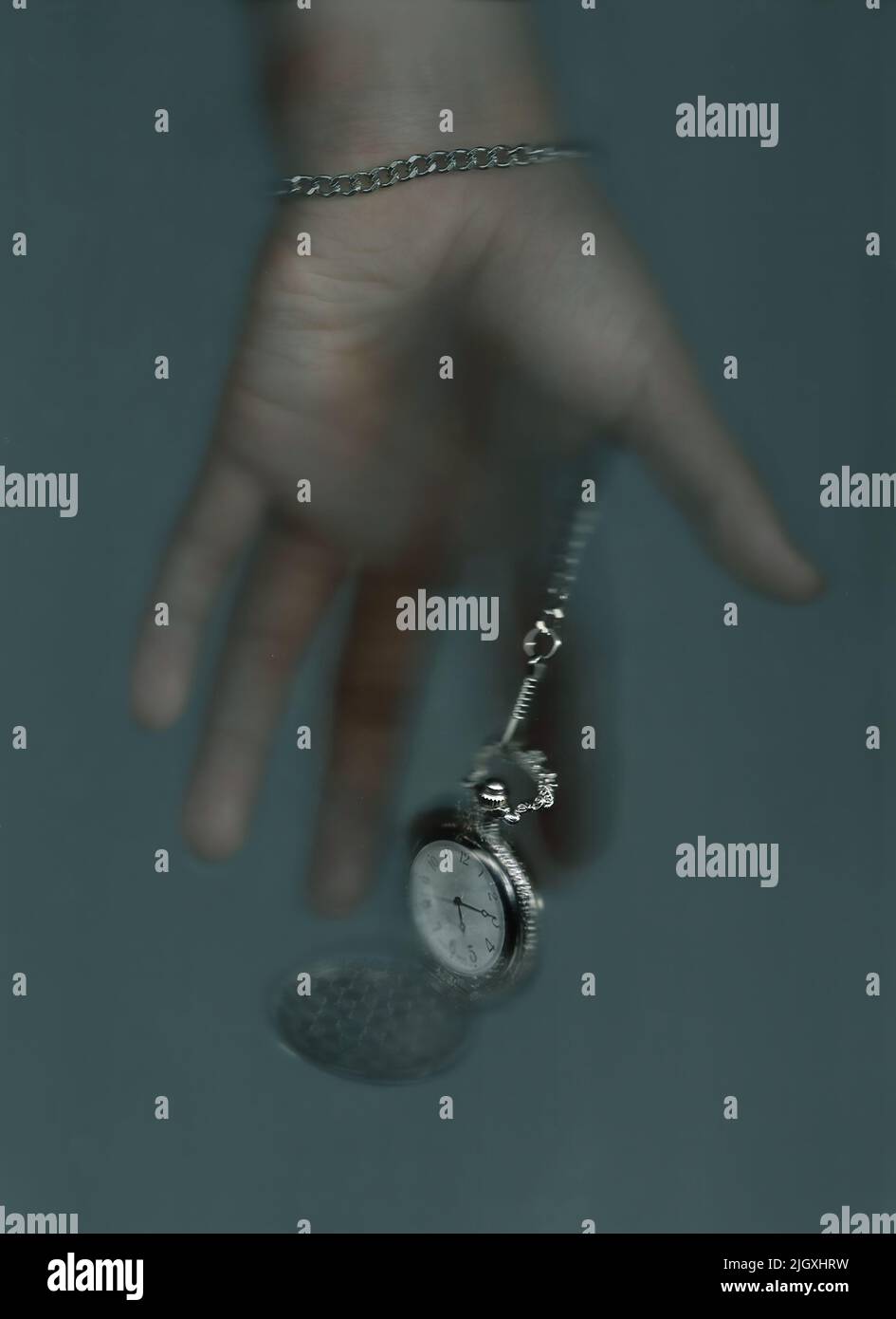 Antique pocket watch fell out of a man's hand in the fog Stock Photo