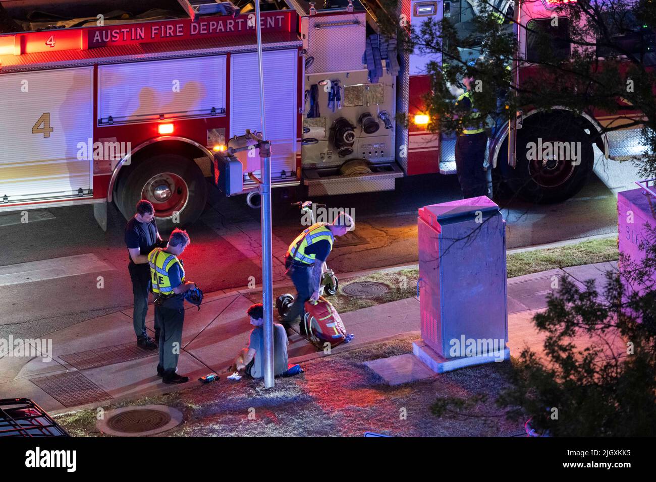 Austin Texas USA, July 2022: Austin Fire Department firefighters evaluate a man hit by a car at the corner of 12th and Guadalupe downtown. He was later transported to the hospital with injuries. ©Bob Daemmrich Stock Photo