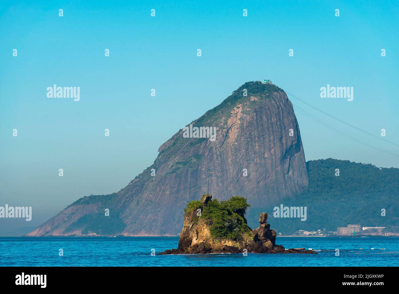 Small Rock in Water With Sugarloaf Mountain Behind Stock Photo - Alamy