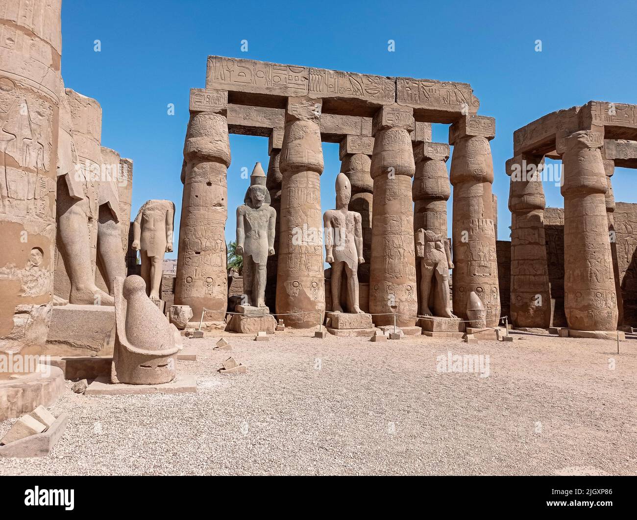 Ruins of an ancient egyptian temple with columns full of hieroglyphs in ...