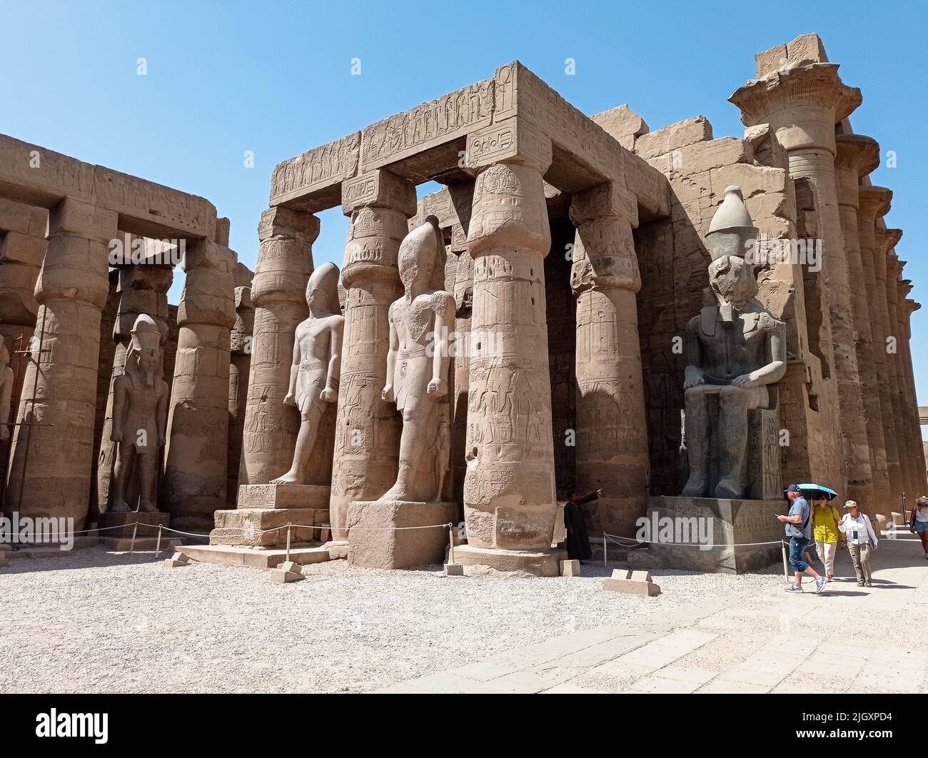 Ruins of an ancient egyptian temple with columns full of hieroglyphs in ...