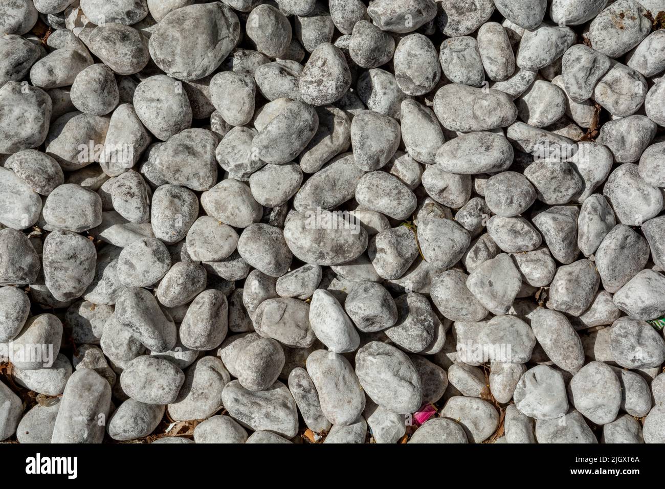 White pebbles stones background. Top view. Stock Photo