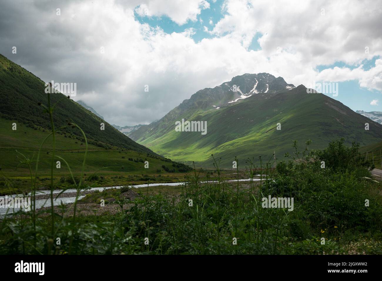 Beautiful landscape with green mountains and cloudy sky Stock Photo - Alamy