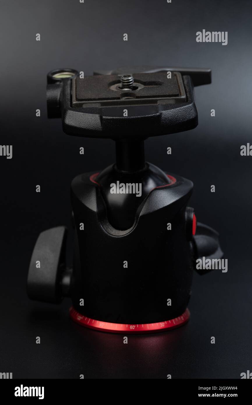 https://c8.alamy.com/comp/2JGXWW4/black-metal-tripod-head-close-up-view-on-studio-background-2JGXWW4.jpg