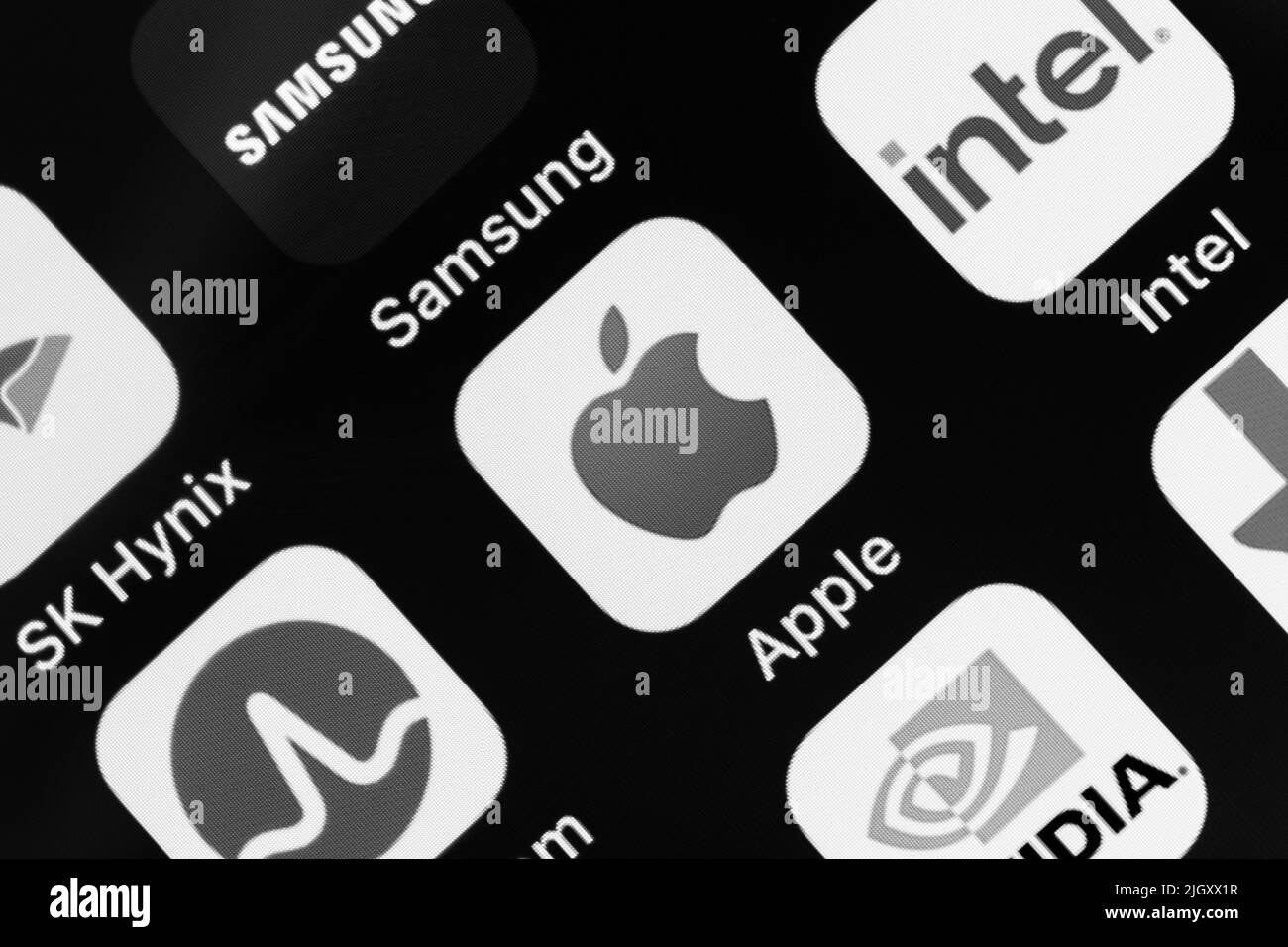 Kumamoto, JAPAN - Mar 30 2022 : Apple inc., logo with popular semiconductor brands, Samsung, Intel, SK Hynix, Broadcom, Nvidia etc on an iPhone in bla Stock Photo