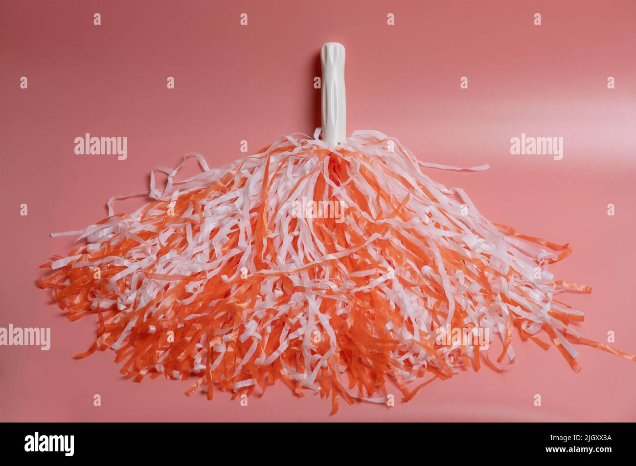 Orange and white color fluffy pom pom isolated close up Stock Photo