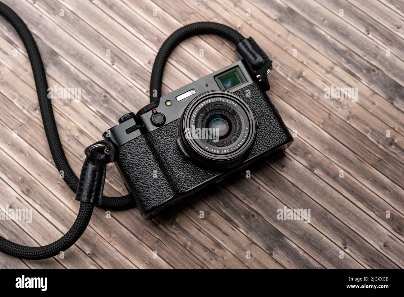 Fujifilm X100V compact camera with a fixed 23 mm Fujinon prime lens. Vintage design photo camera for creative people and photographers. Easy to use. Stock Photo