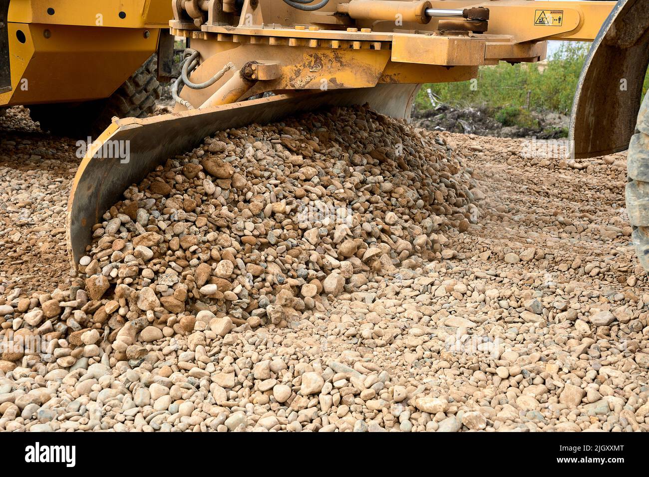 the grader blade levels the rubble at the construction site Stock Photo ...