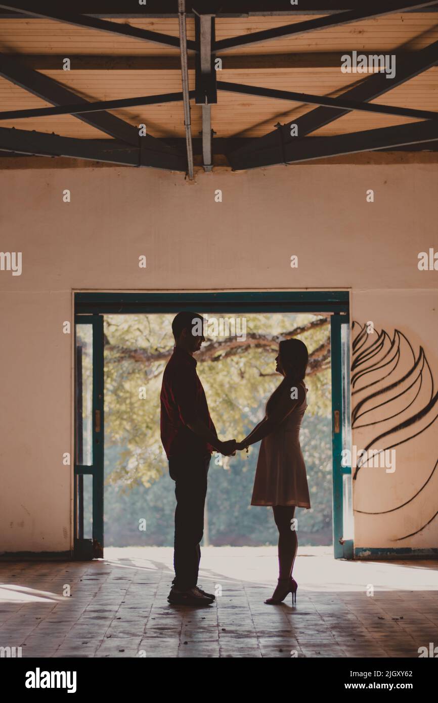 silhouette of standing couple holding hands Stock Photo - Alamy