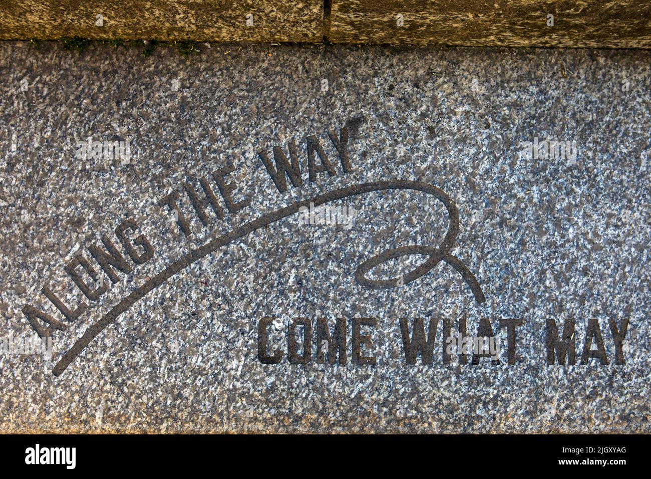 Glasgow, Scotland - October 15th 2021: A paving stone in Glasgow city centre, portraying the phrase Along the Way Come What May. Stock Photo