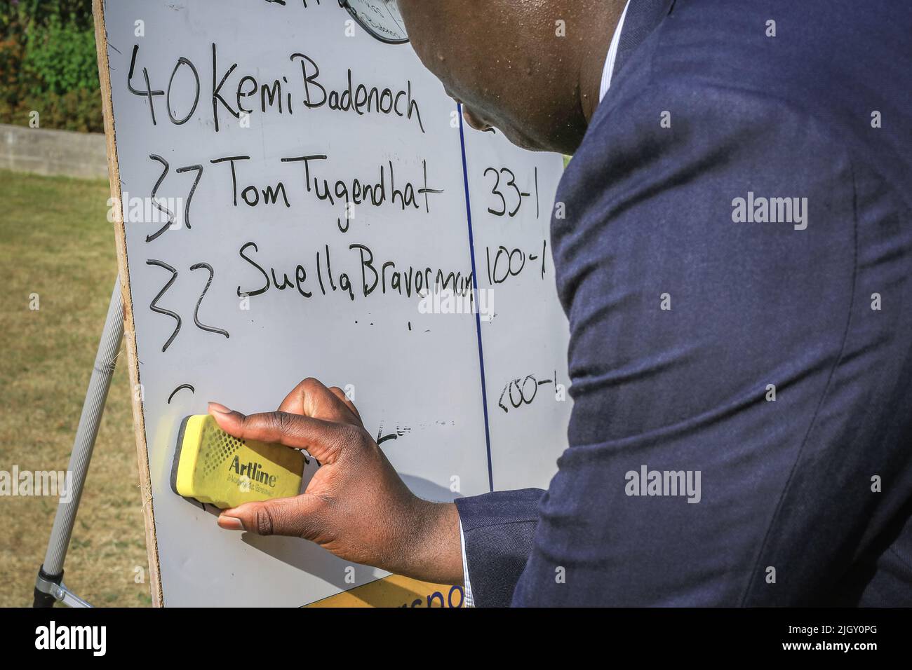 London, UK. 13th July, 2022. William Kedjanyi of Star Sports betting company wipes out the names of the two leadership contenders who have dropped out of the race, Nadhim Zahawi and Jeremy Hunt, following the first round knockout vote in Parliament by Conservative MPs. His tote board showing the odds for leadership candidates in the race. Credit: Imageplotter/Alamy Live News Stock Photo