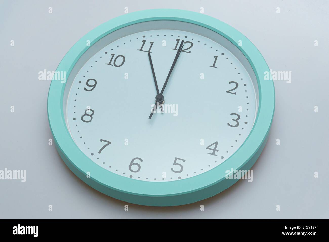 Wall clock showing various times on a white background Stock Photo Alamy
