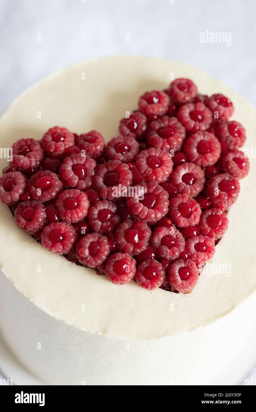 Valentine's Day cake decorated with raspberry heart closeup view. Stock Photo