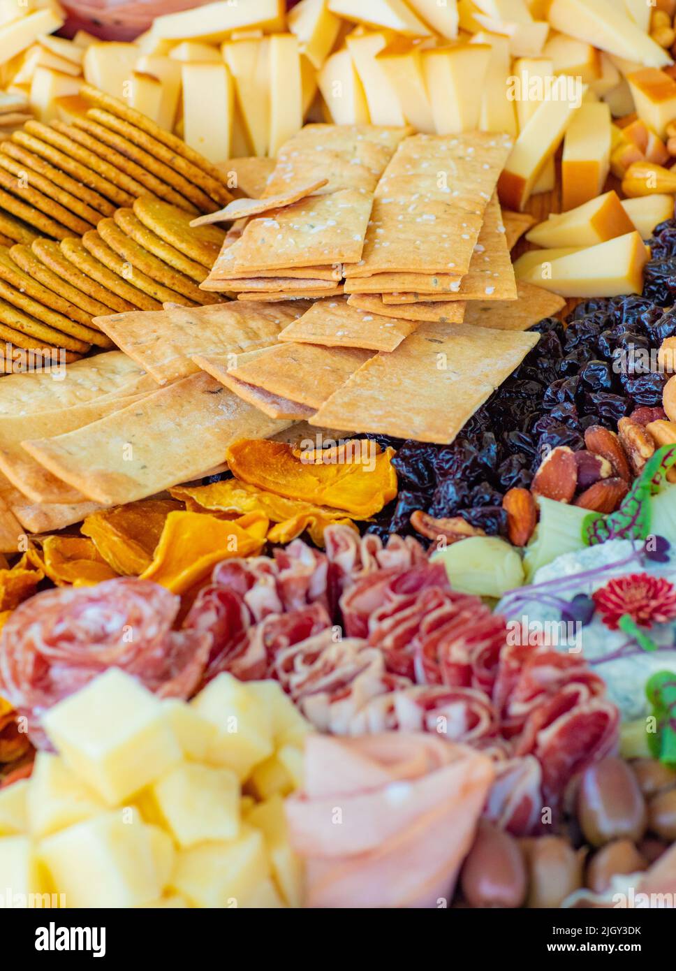 Tasty sausage roses, nuts, pieces of cheese, crackers, dried fruits ...