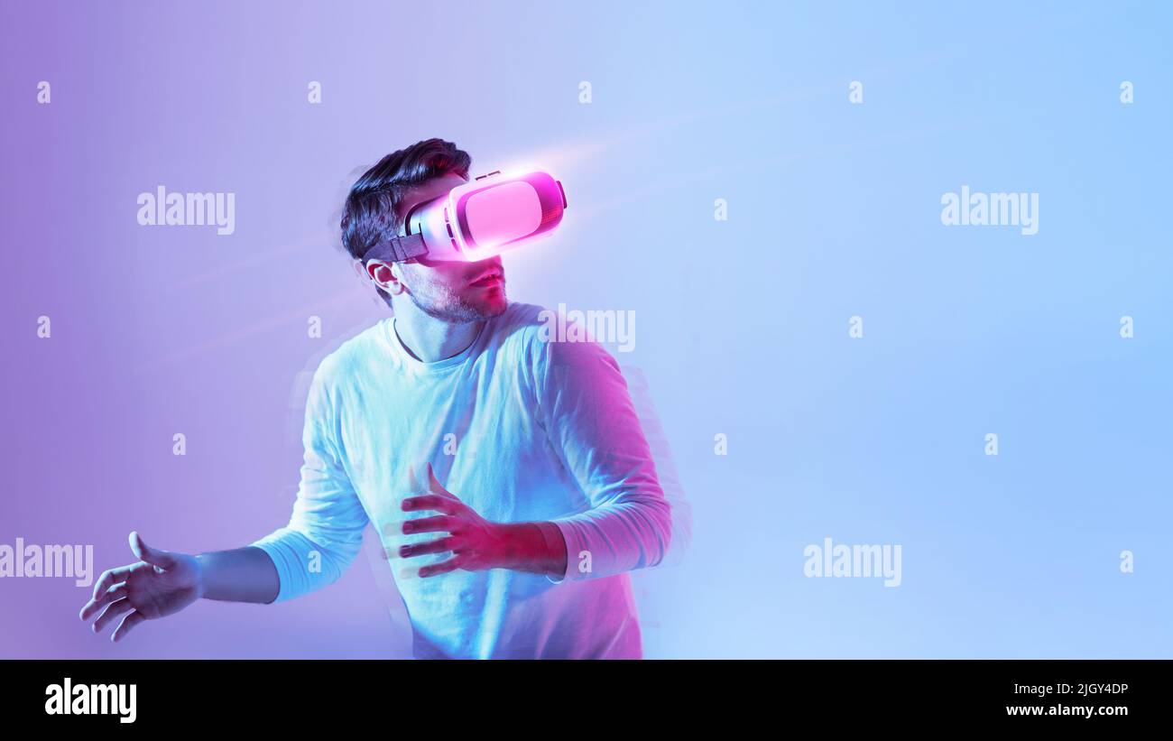 Millennial guy using modern headset, experiencing virtual reality Stock Photo