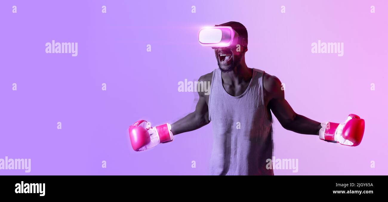 Aggressive black sportsman in VR headset and boxing gloves shouting