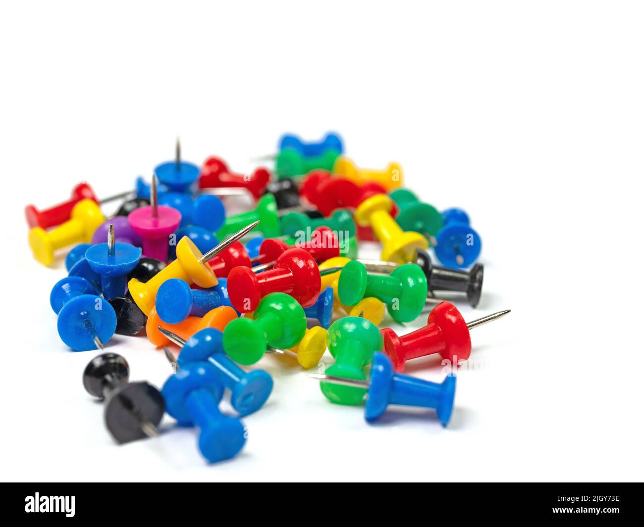 Colorful pushpins against a white background Stock Photo