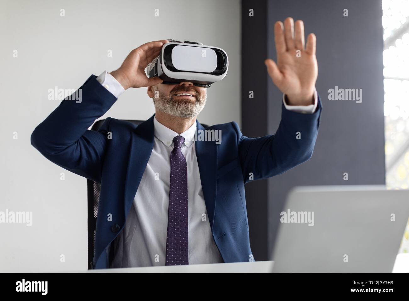 Modern Technologies. Excited Middle Aged Businessman Using VR Glasses In Office Stock Photo