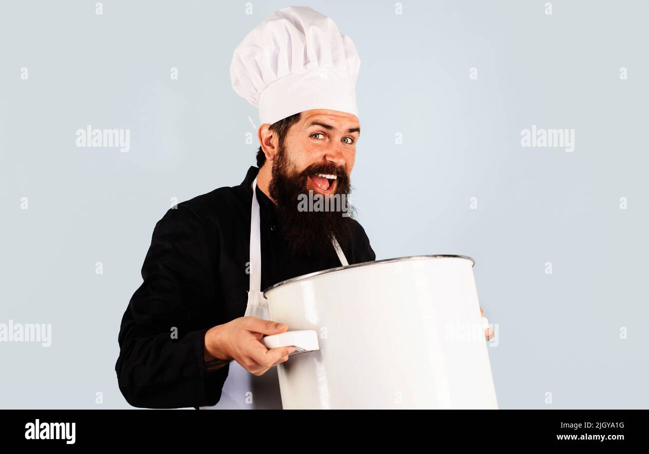 Professional chef with cooking pot. Bearded man in cook uniform with saucepan. Food preparation. Stock Photo