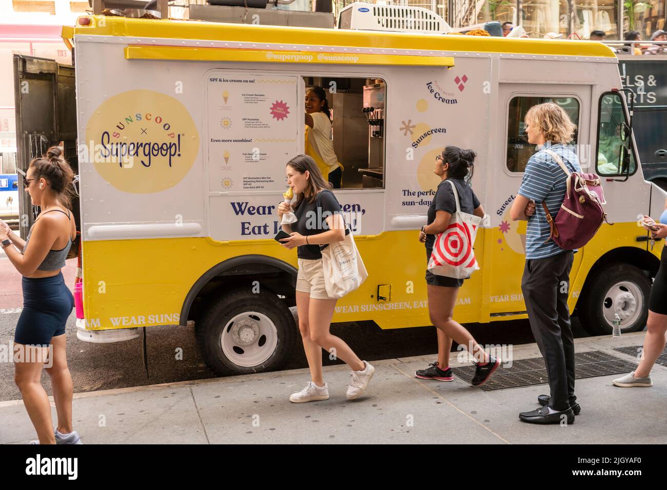 Driven by social media and word of mouth hundreds of people arrive and wait on line to receive free soft-serve ice cream from Sunscoop in collaboration with Supergoop, a maker of sunscreen skincare products, in Soho in New York on Thursday, July 7, 2022. (© Richard B. Levine) Stock Photo