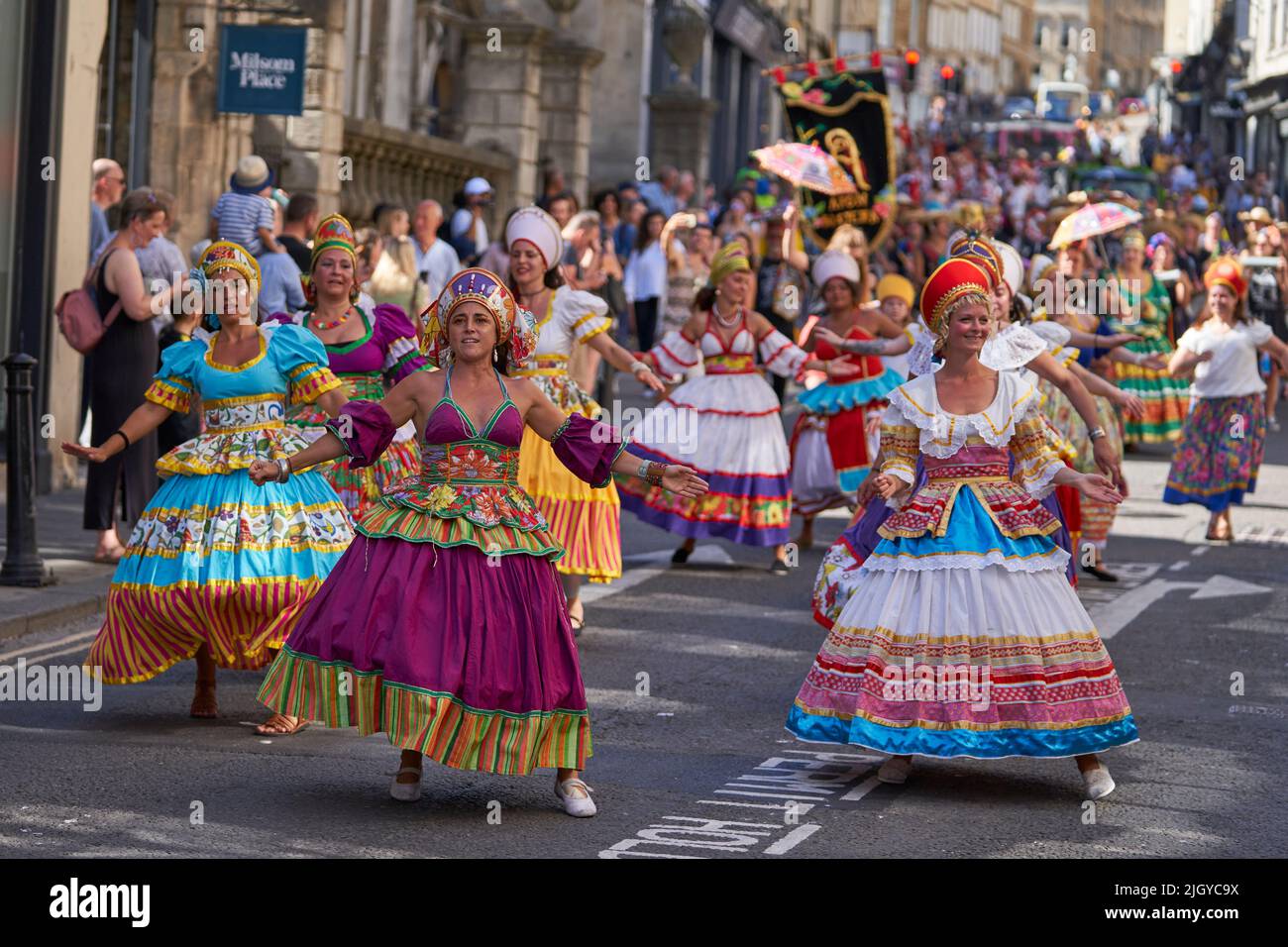 Dancers in ornate costumes performing at the annual carnival as it progresses through the streets of the historic city of Bath in Somerset. Stock Photo