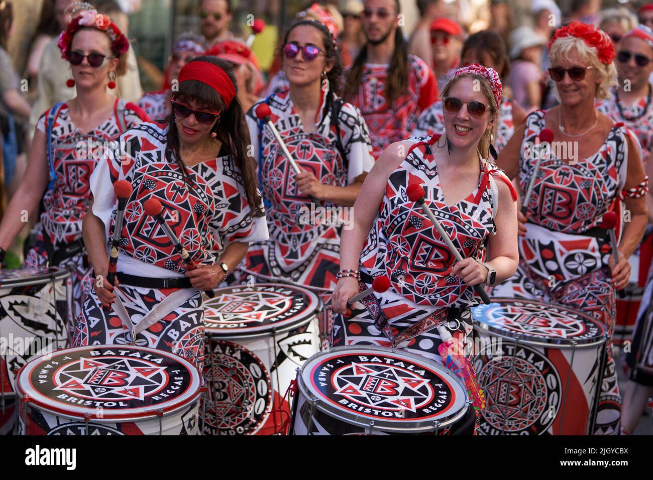 Drumming band performing at the annual carnival as it progresses through the streets of the historic city of Bath in Somerset. Stock Photo