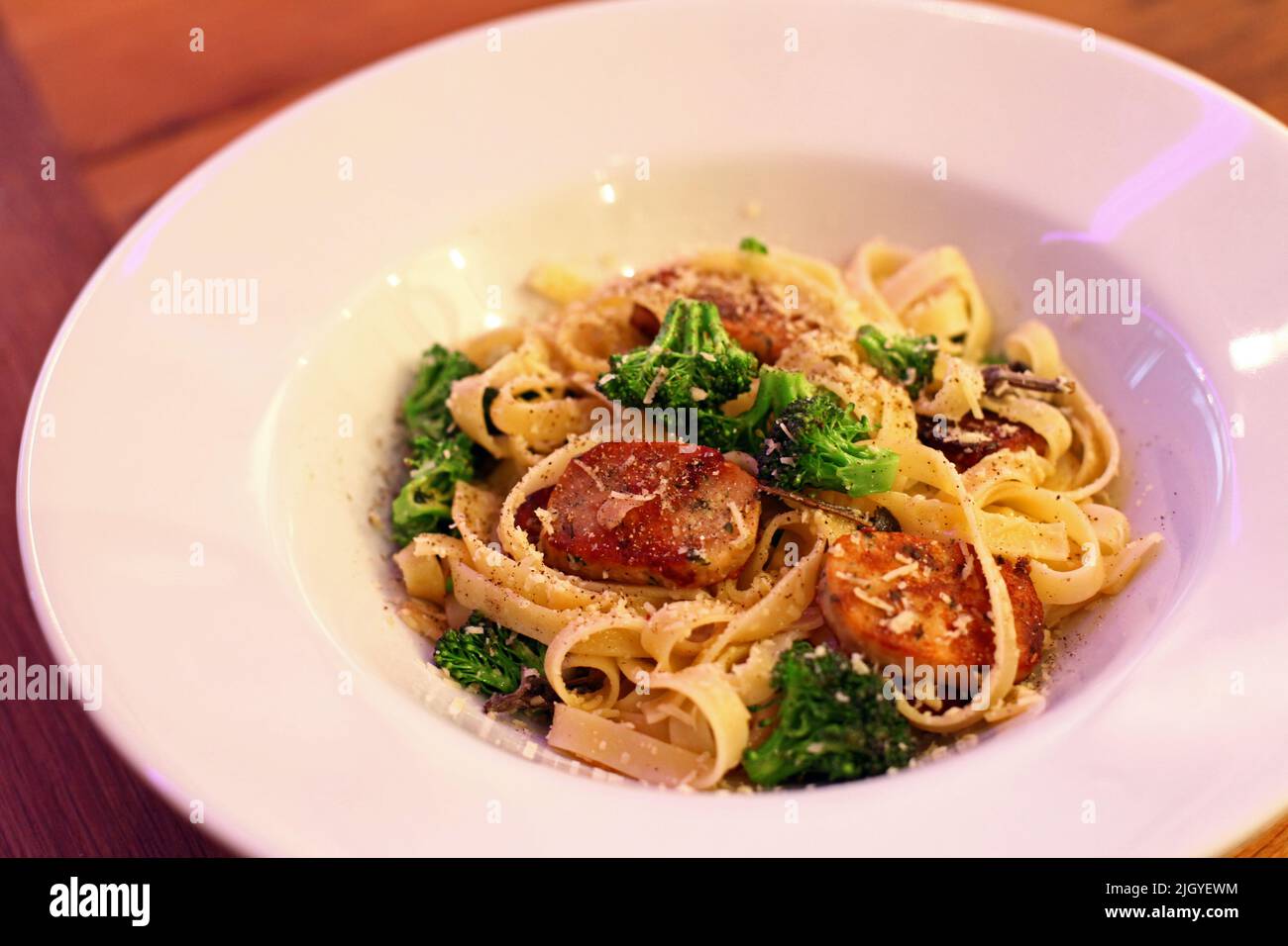 Pasta with broccoli and salmon fish in the dinner plate. Stock Photo