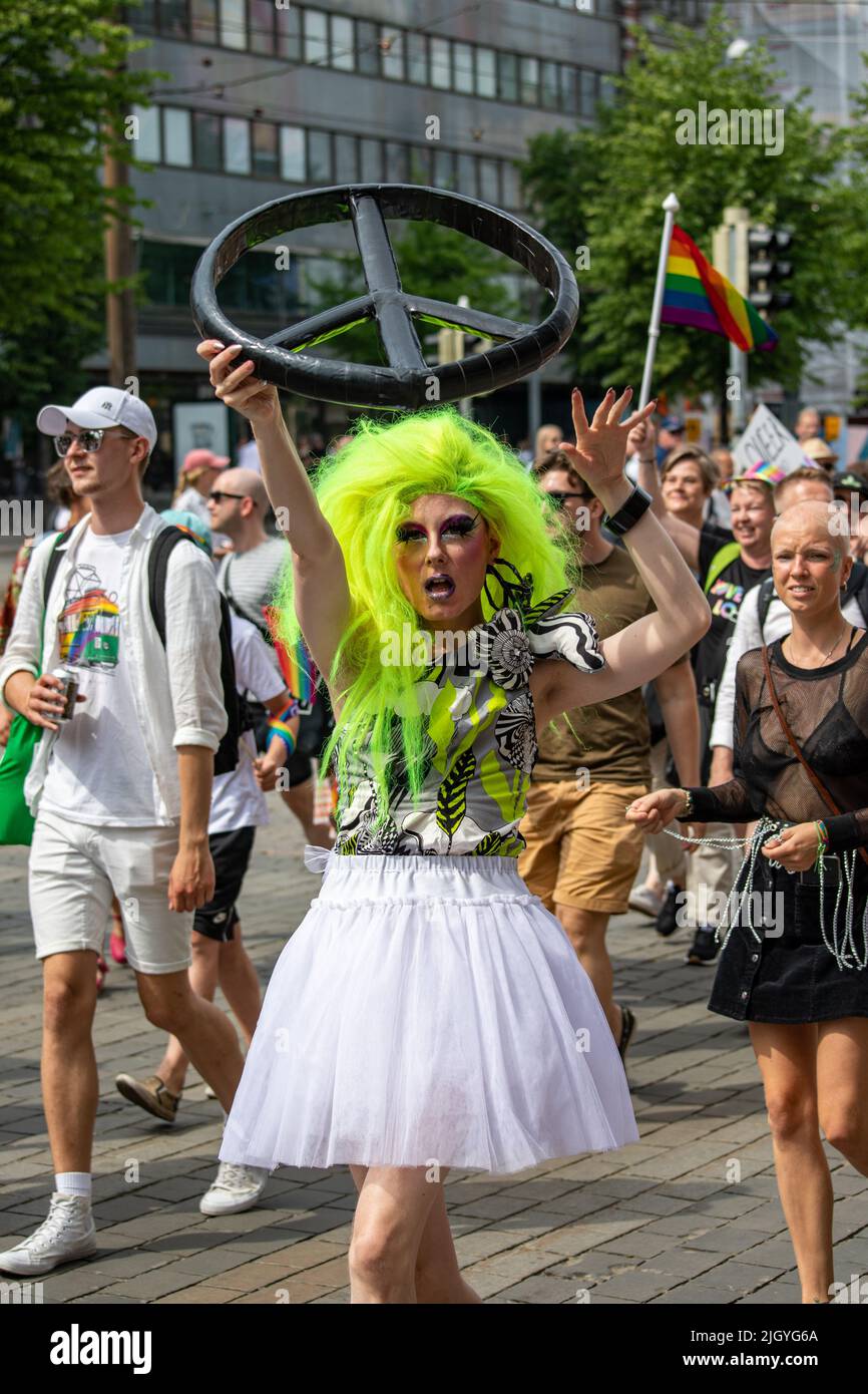 Drag queen carrying large peace-sign at Helsinki Pride 2022 Parade in Mannerheimintie, Helsinki, Finland Stock Photo