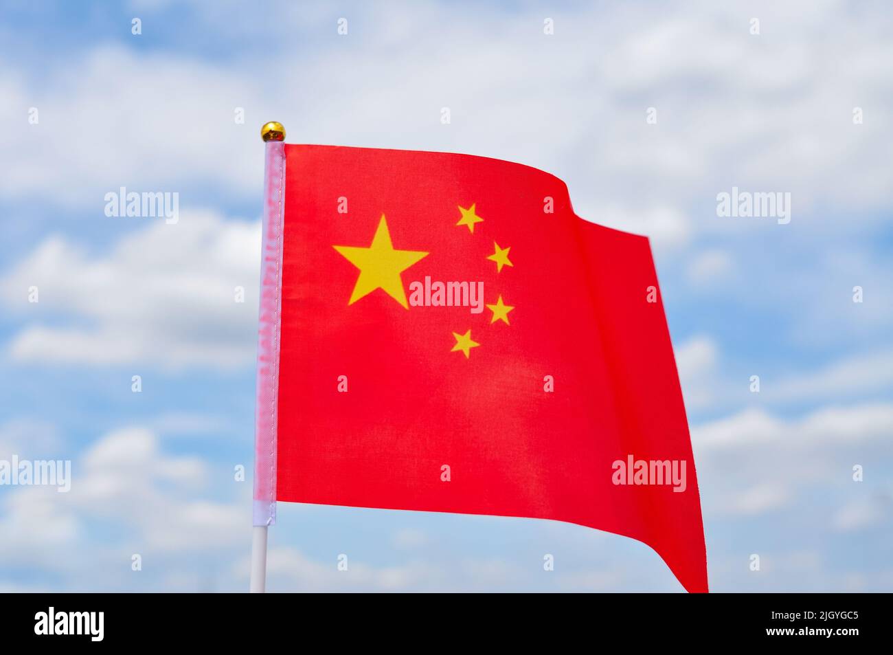national flag of China red color and yellow stars close up Stock Photo