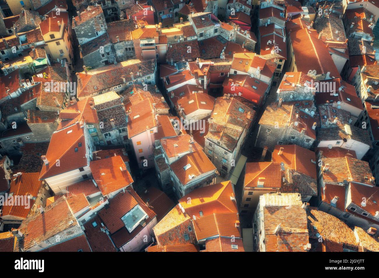 Aerial view of houses with orange roofs at sunset in summer Stock Photo