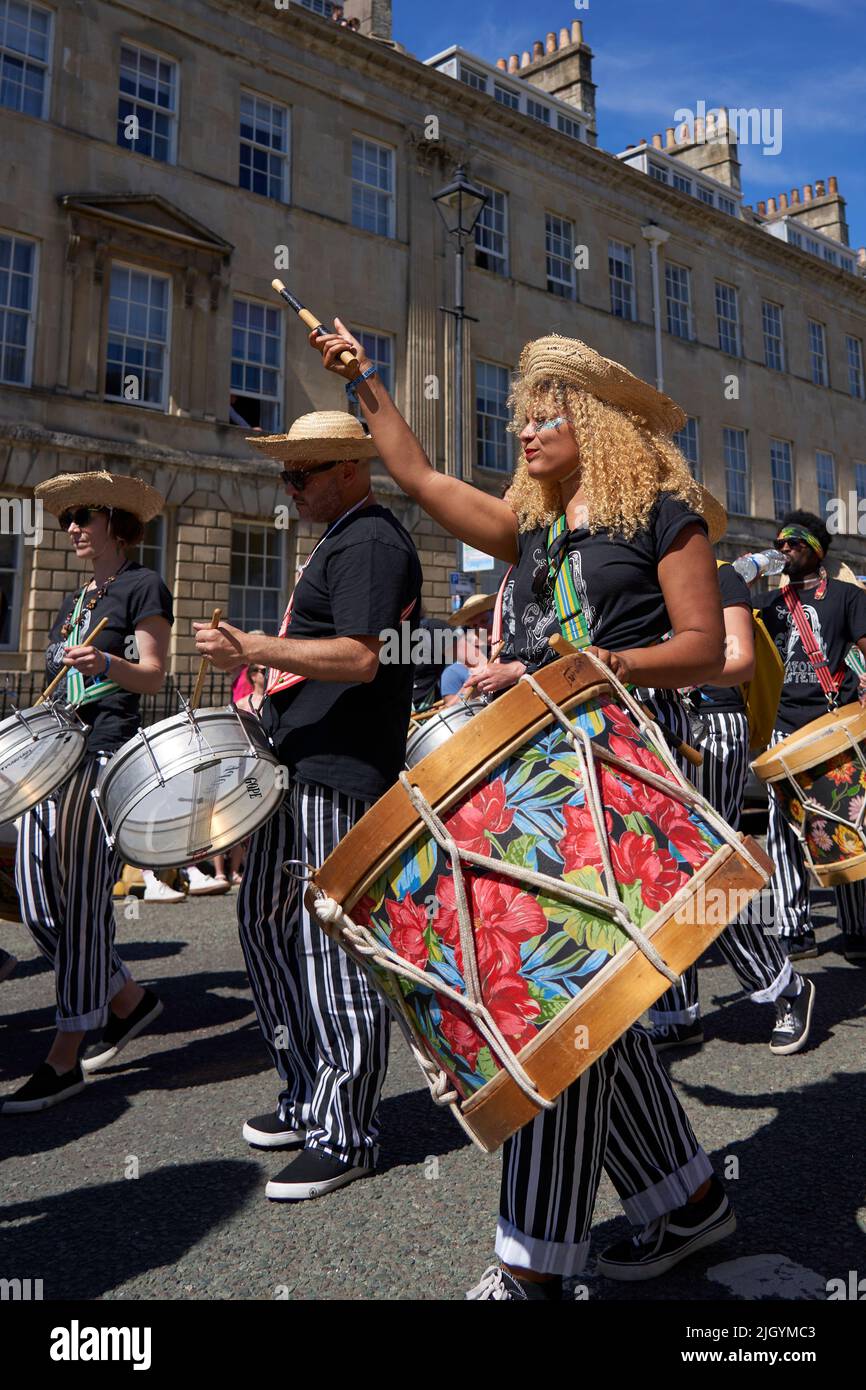 Drumming band performing at the annual carnival as it progresses through the streets of the historic city of Bath in Somerset. Stock Photo