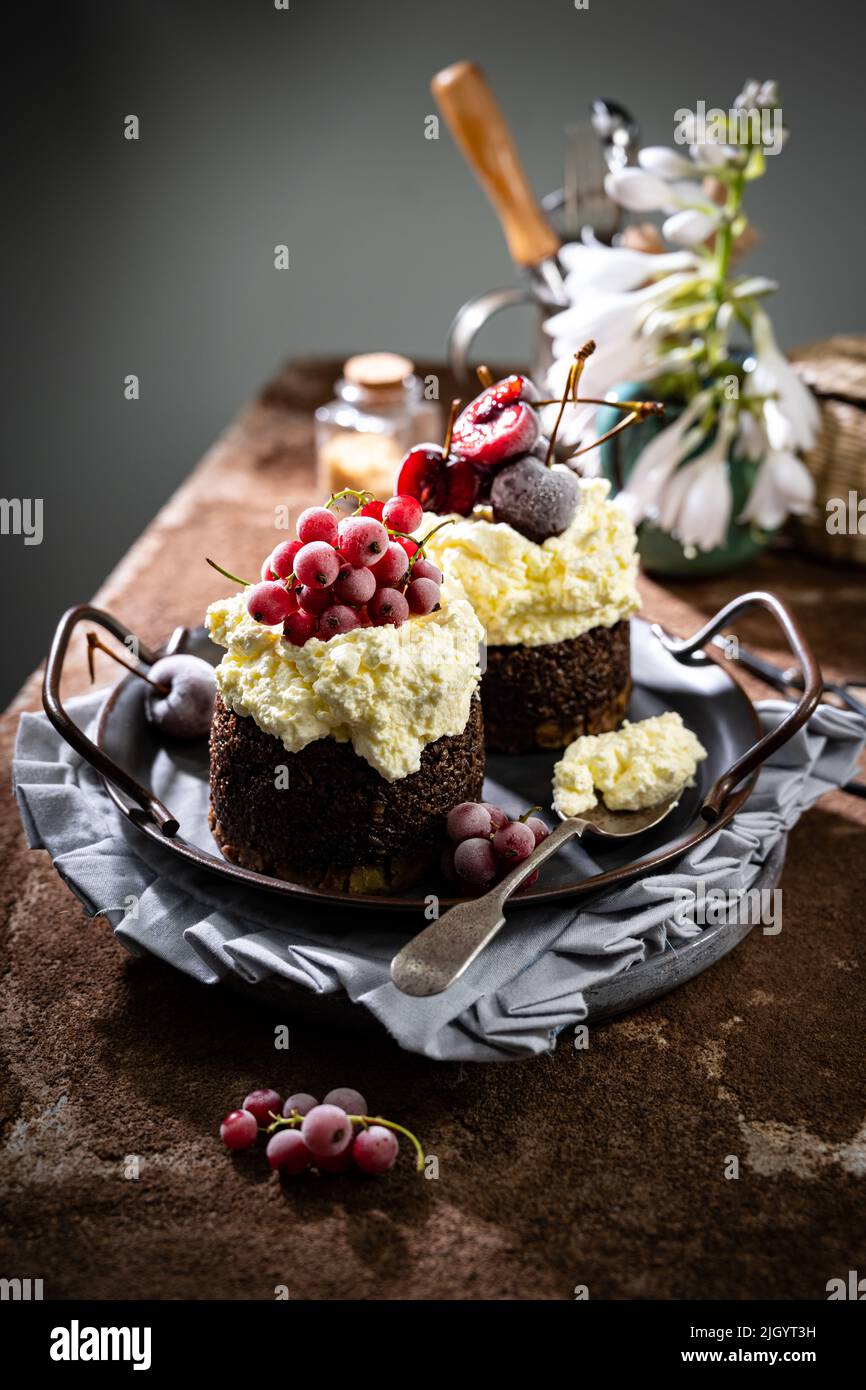Sweet chocolate dessert with cream and frozen fruit.Delicious food and drink.Homemade cake Stock Photo