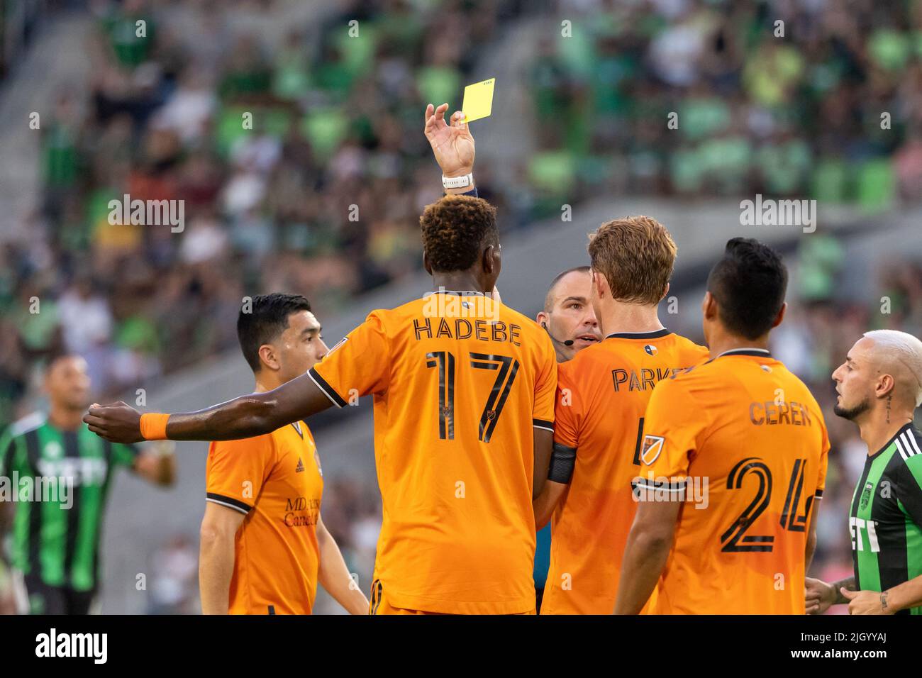 AUSTIN, TX - JULY 12: Houston Dynamo defender Teenage Hadebe (17) receives  a yellow card during the first half of the MLS match between Austin FC and  Houston Dynamo on July 12,