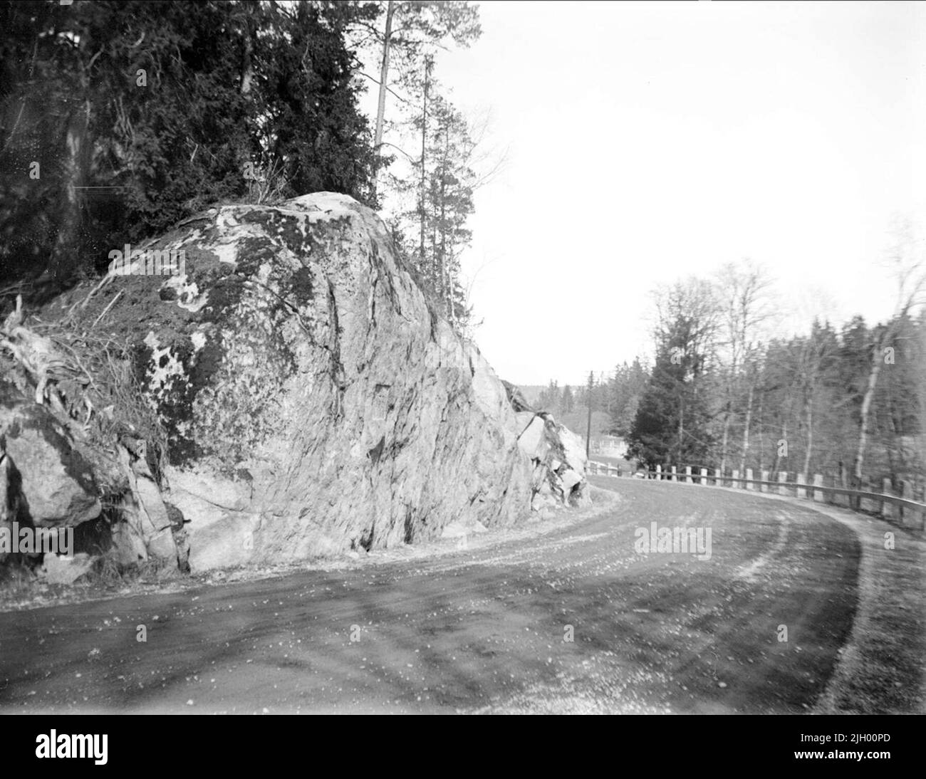 Large boulders, the one of some called Lurbook cliff, alongside the road in Lurbo, Gottsunda, Uppsala in April 1934. Large boulders, the one of some called Lurbook cliff, alongside the road in Lurbo, Gottsunda, Uppsala in April 1934 Stock Photo