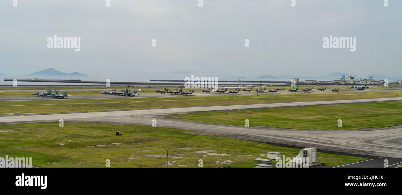 The U.S. Air force 354th Air Expeditionary Wing and Marine Aircraft Group 12 performed a capabilities demonstration during a pre-planned readiness exercise at Marine Corps Air Station Iwakuni, Japan, July 7, 2022. The demonstration included five U.S. Marine Corps F/A-18 Hornets, eight F-35B Lightning IIs, a KC-130J Super Hercules, 10 U.S. Air Force F-22 Raptors and 10 F-35A Lightning II aircraft, showcasing a high level of readiness and joint service capability in support of a free and open Indo-Pacific. MCAS Iwakuni is uniquely qualified to enable the Joint Force, be it through providing use Stock Photo