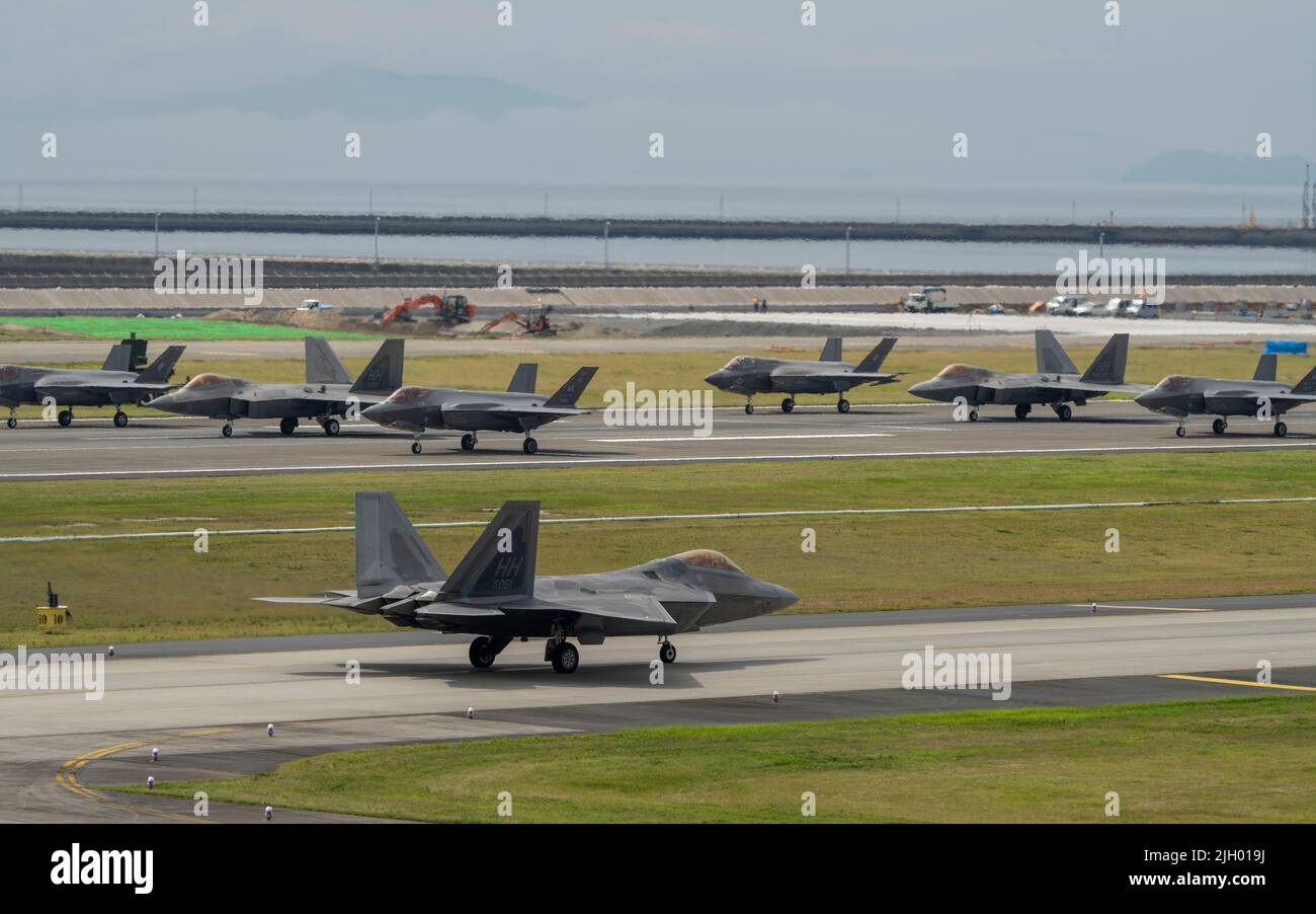 The U.S. Air force 354th Air Expeditionary Wing and Marine Aircraft Group 12 performed a capabilities demonstration during a pre-planned readiness exercise at Marine Corps Air Station Iwakuni, Japan, July 7, 2022. The demonstration included five U.S. Marine Corps F/A-18 Hornets, eight F-35B Lightning IIs, a KC-130J Super Hercules, 10 U.S. Air Force F-22 Raptors and 10 F-35A Lightning II aircraft, showcasing a high level of readiness and joint service capability in support of a free and open Indo-Pacific. MCAS Iwakuni is uniquely qualified to enable the Joint Force, be it through providing use Stock Photo