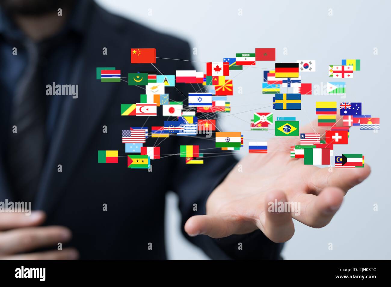 A person presenting a virtual projection of different country flags Stock Photo