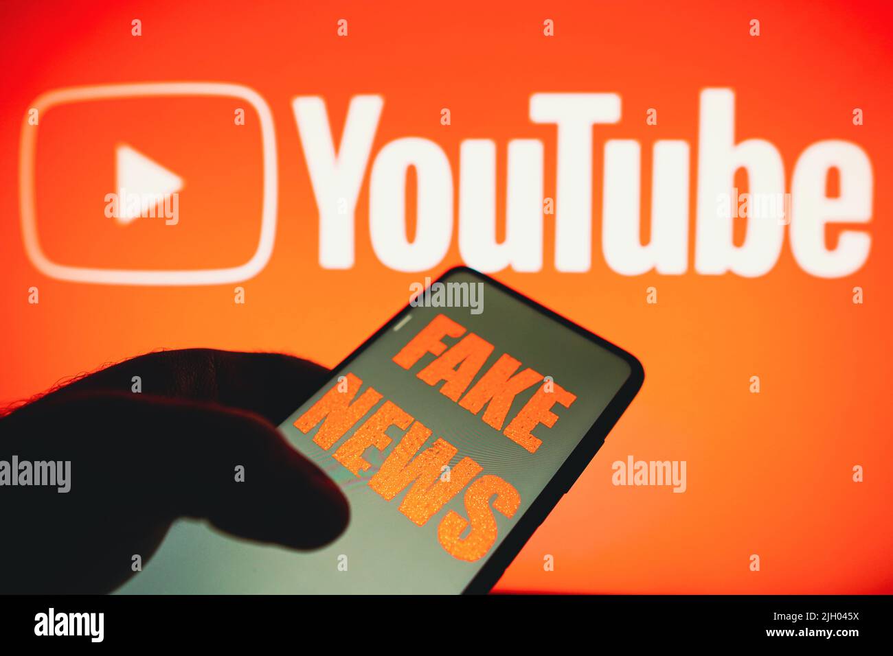 In this photo illustration, the words 'fake news' are displayed on a  smartphone with a YouTube logo in the background. (Photo by Rafael Henrique  / SOPA Images/Sipa USA Stock Photo - Alamy